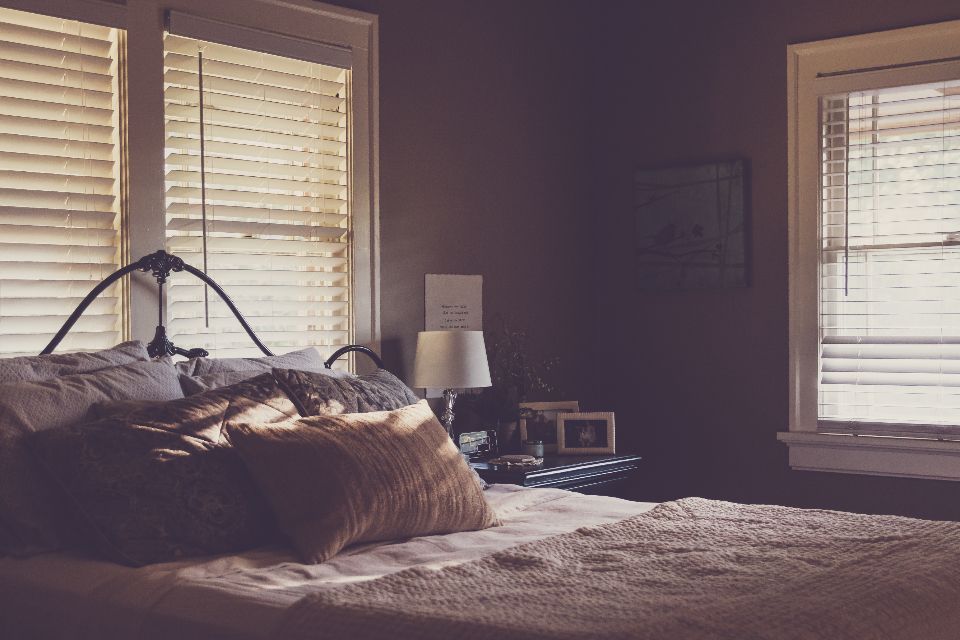 A guest room with a large bed and soft lighting